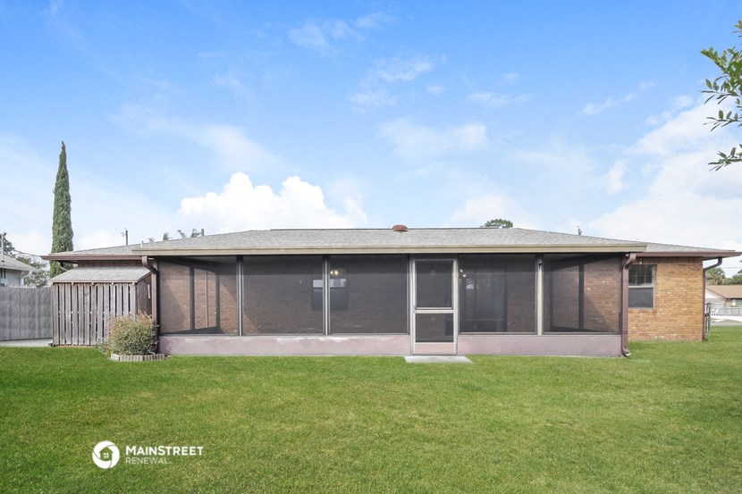 the front of a brick house with a grass yard