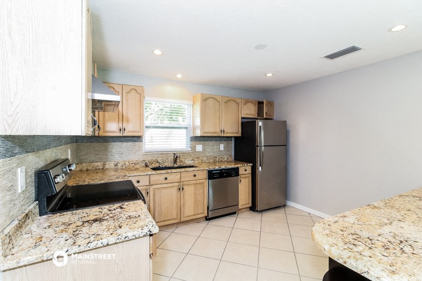 a kitchen with granite counter tops and stainless steel appliances