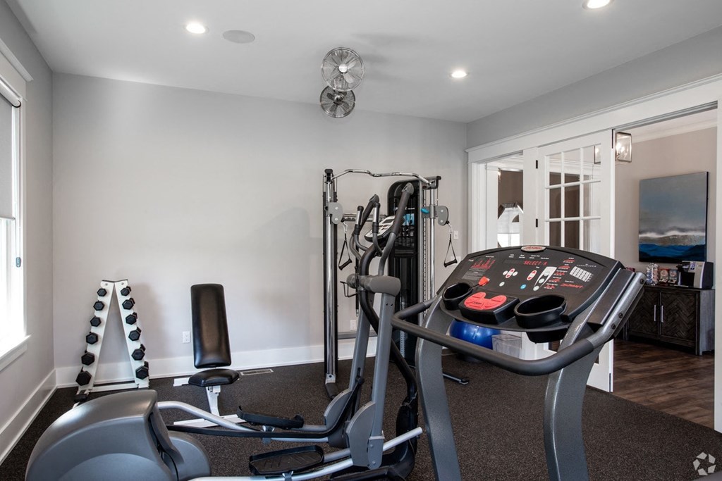 a home gym with a treadmill and exercise equipment