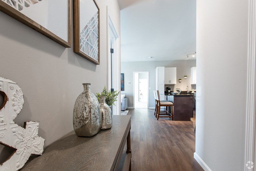 a living room with a wooden table and vases on it