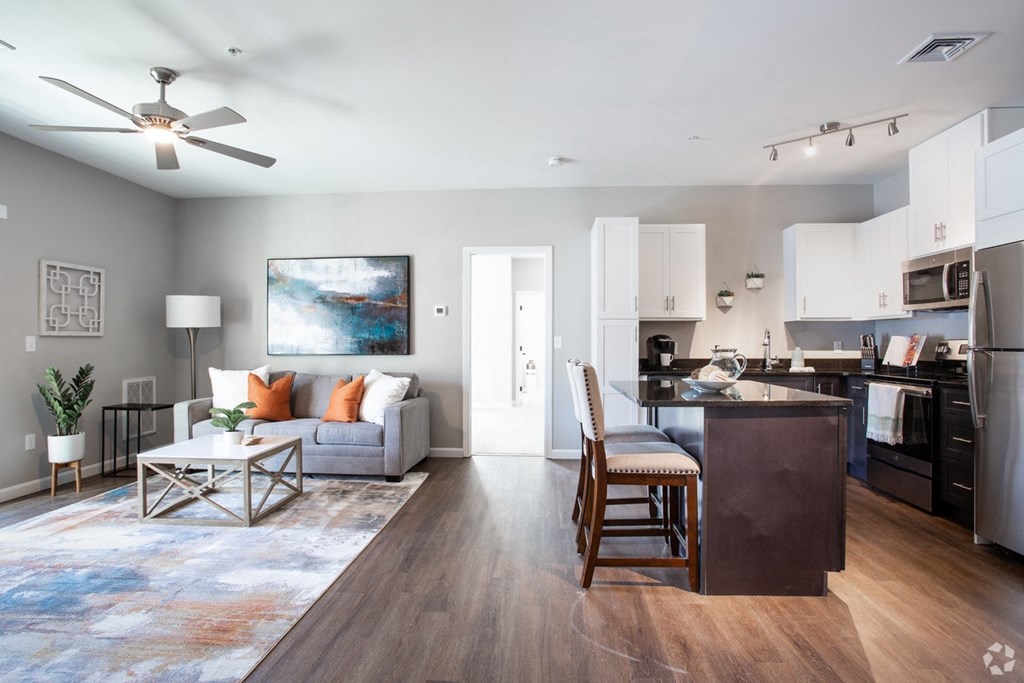 a living room with a couch and a kitchen