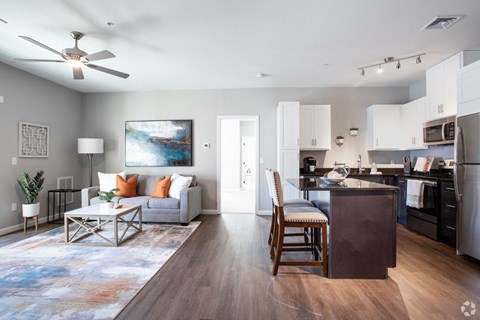 a living room with a couch and a kitchen