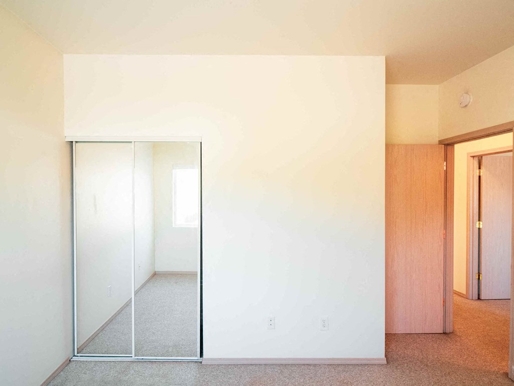 an empty room with a mirror in it