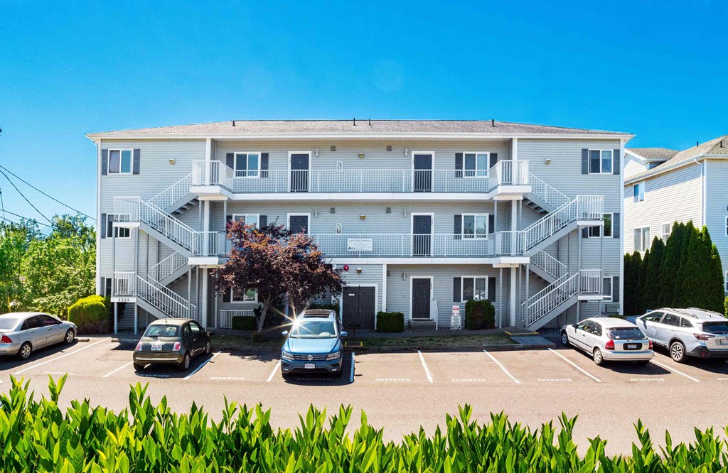 a large white building with cars parked in front of it