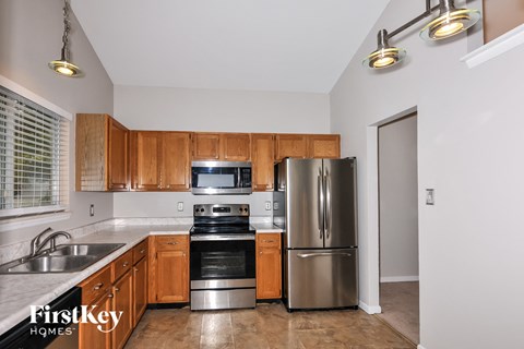 A kitchen with wooden cabinets and stainless steel appliances.