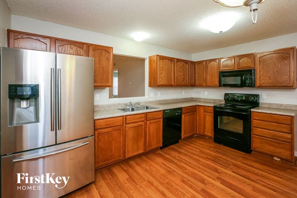 a kitchen with wooden cabinets and stainless steel appliances