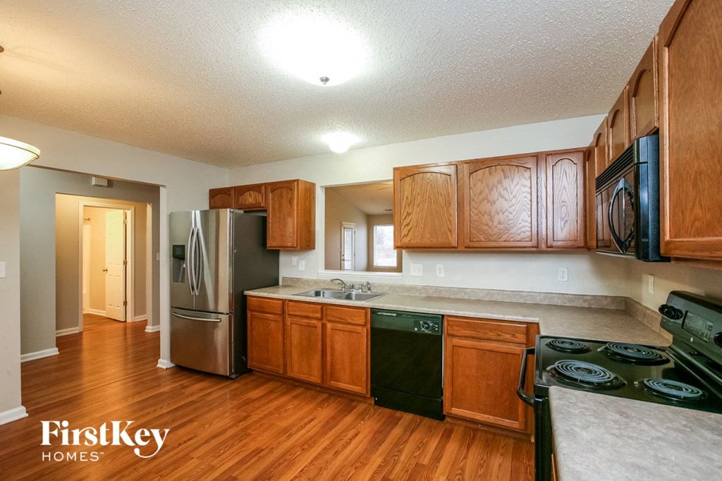a kitchen with wooden cabinets and stainless steel appliances