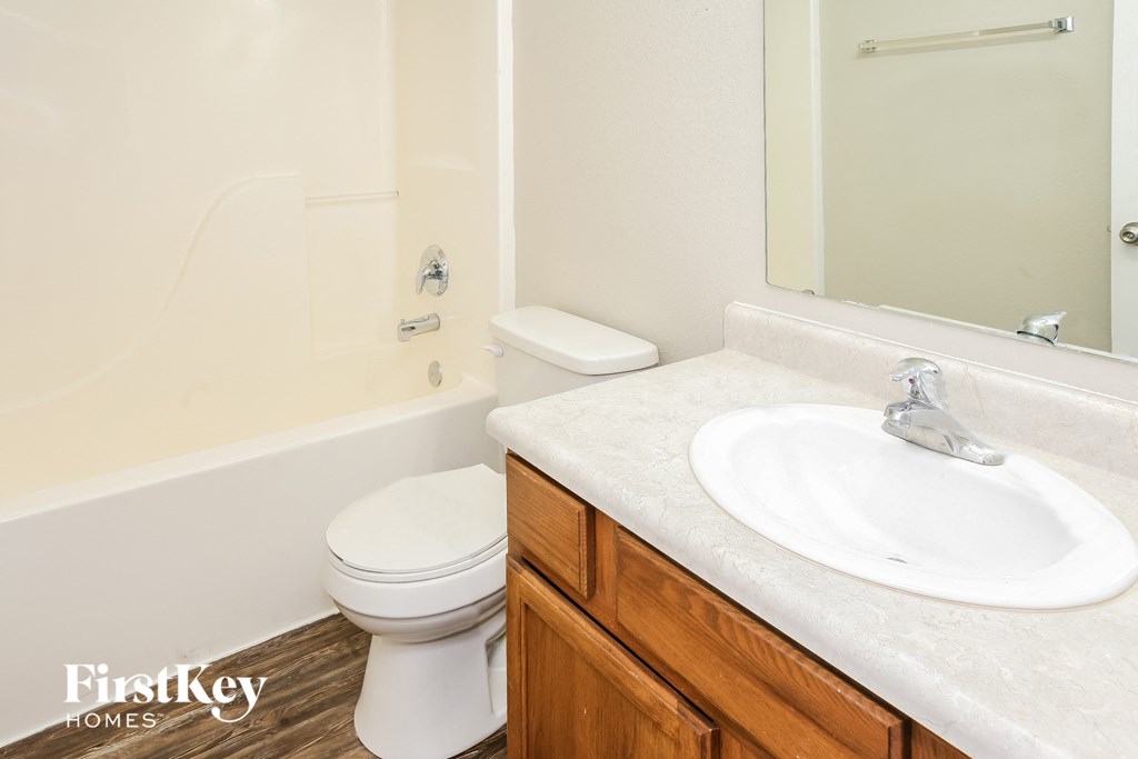 a bathroom with a toilet and a sink and a mirror