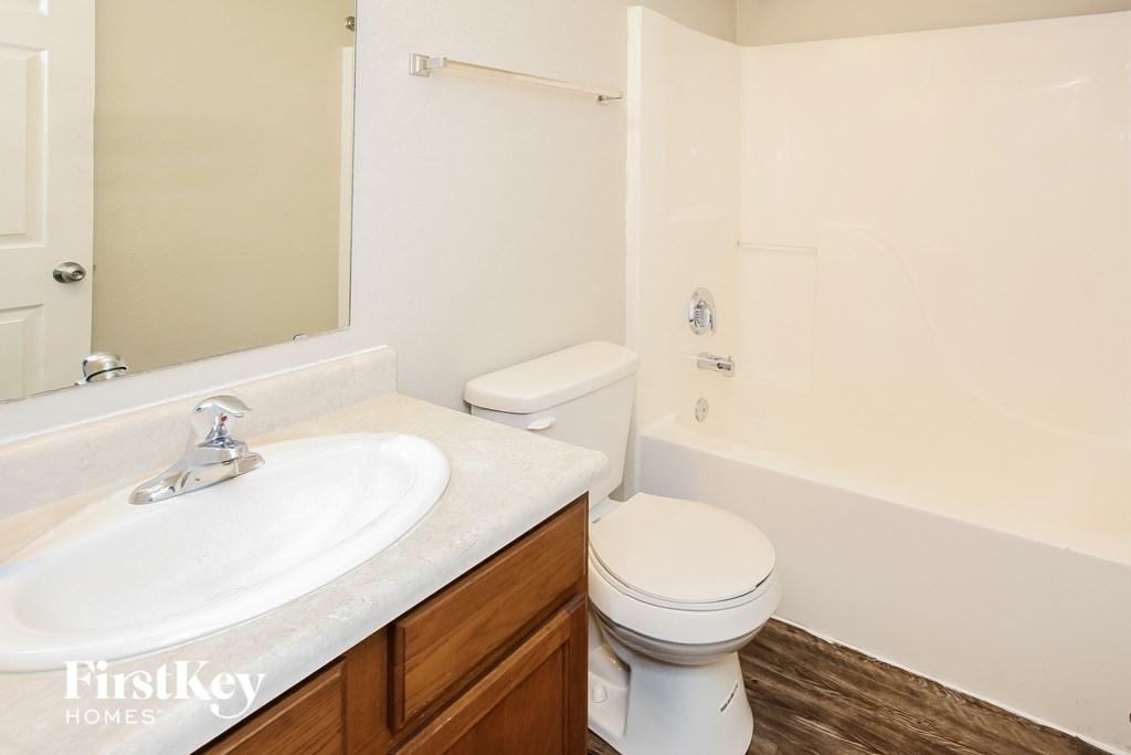 a bathroom with a toilet and a sink and a mirror