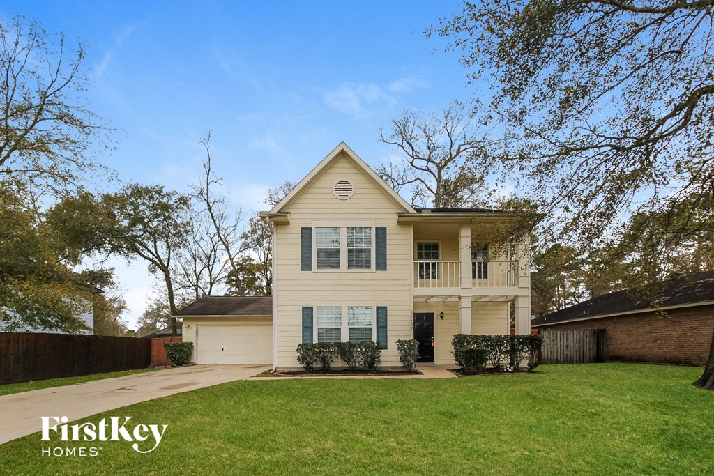 a white house with a lawn and a yard