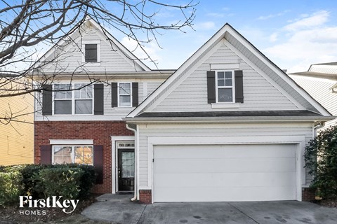 the front of a house with a white garage door