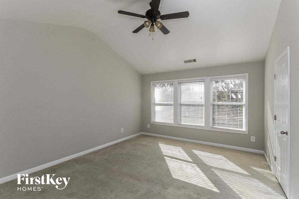 a living room with a ceiling fan and a window
