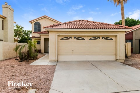 a home with a white garage door and a driveway