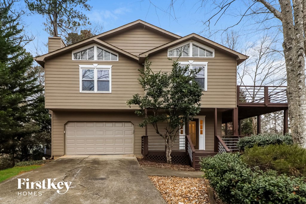 A two-story house with a garage is for sale.