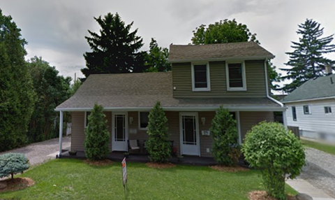 a house with a flag in the front yard