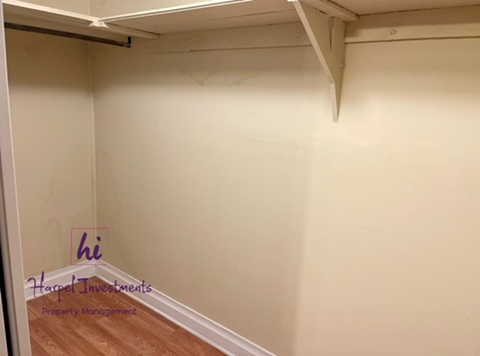 A room with a wooden floor and white walls.