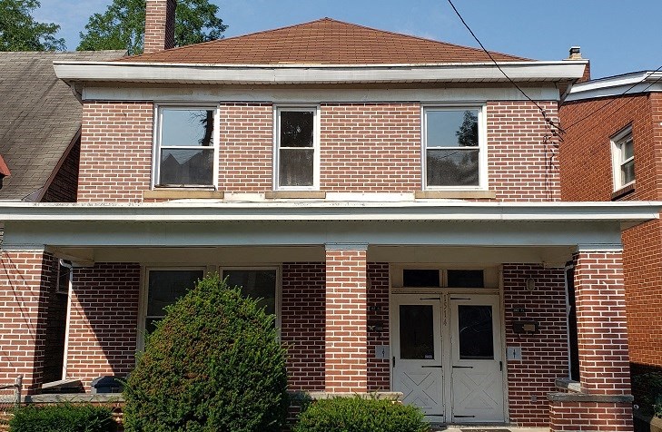 a brick house with two white doors