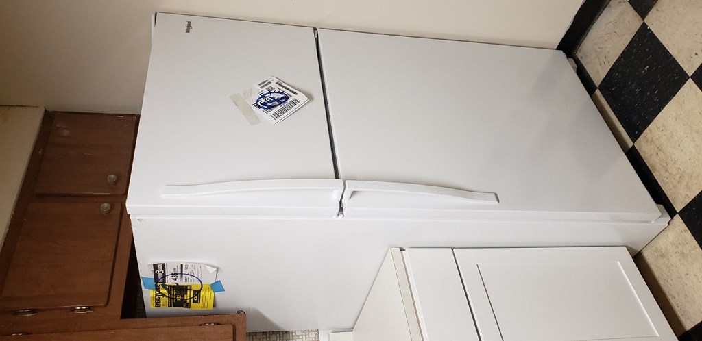 a white refrigerator freezer sitting in a kitchen