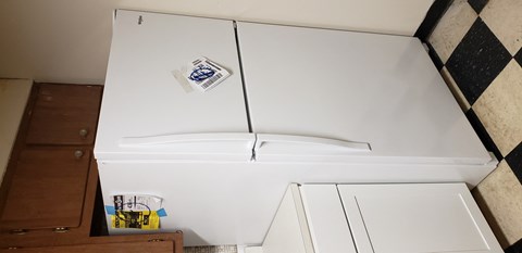 a white refrigerator freezer sitting in a kitchen