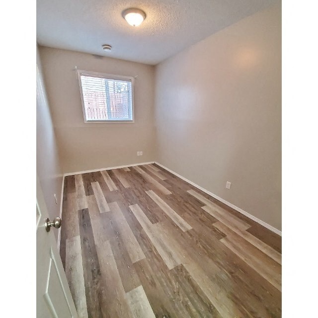 a room with a hard wood floor and a window