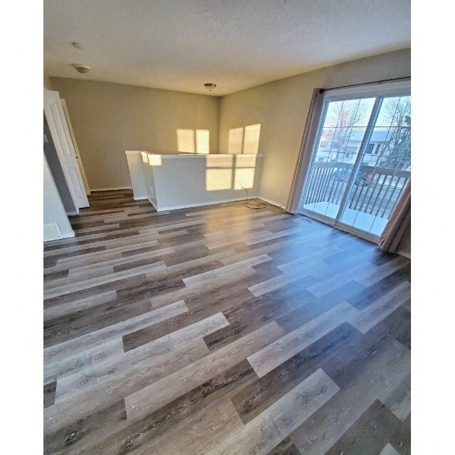 a living room with wood floors and a sliding glass door