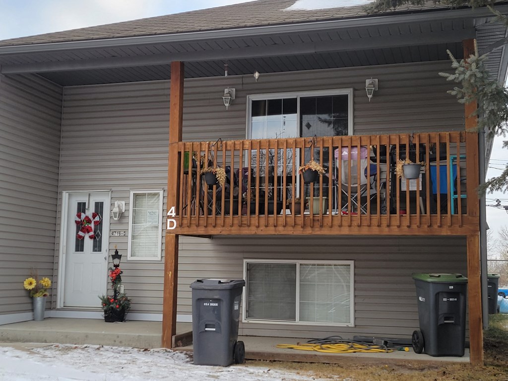 the front of our house with a deck and a porch