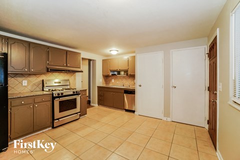 full view of the kitchen with stainless steel appliances and wooden cabinets