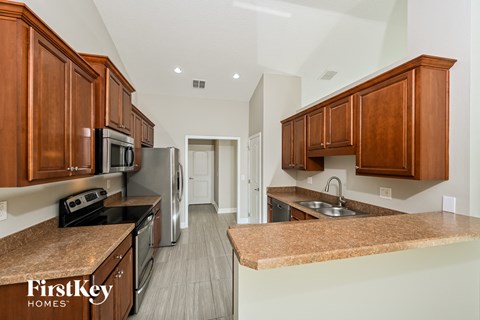 a kitchen with wooden cabinets and granite counter tops