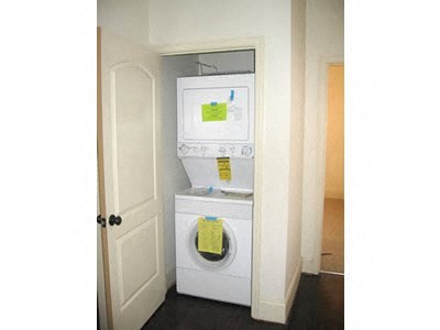 a white washer and dryer in a room with a door