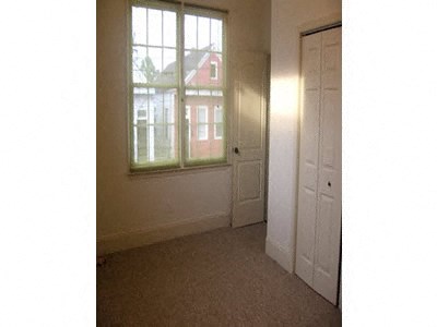 an empty room with a window and a door
