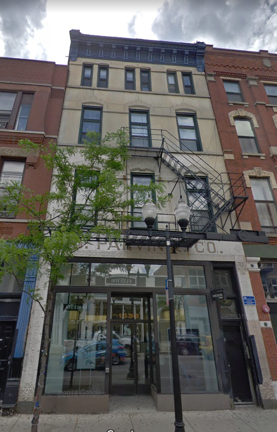 the front of a building with a fire escape