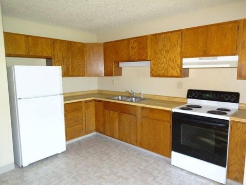 a kitchen with a stove refrigerator and a sink