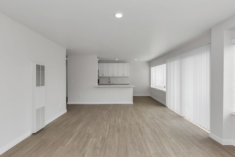 A room with a wooden floor and white walls.