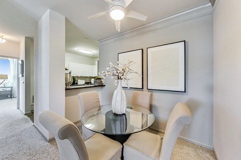 a dining room with a glass table and chairs