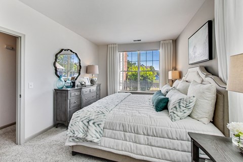 a bedroom with a large bed and a window