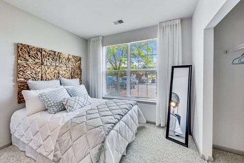 a bedroom with a large bed and a large window