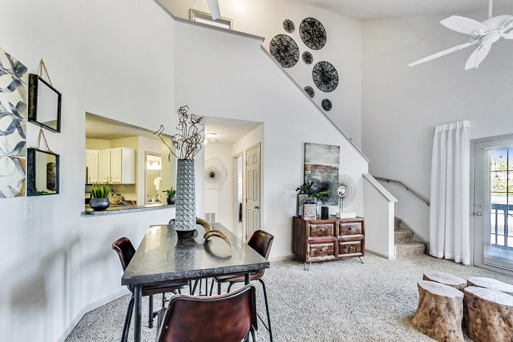 a dining room with a table and chairs and a ceiling fan