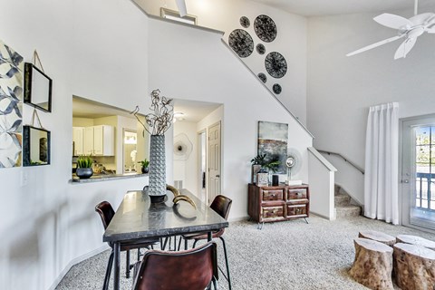 a dining room with a table and chairs and a ceiling fan