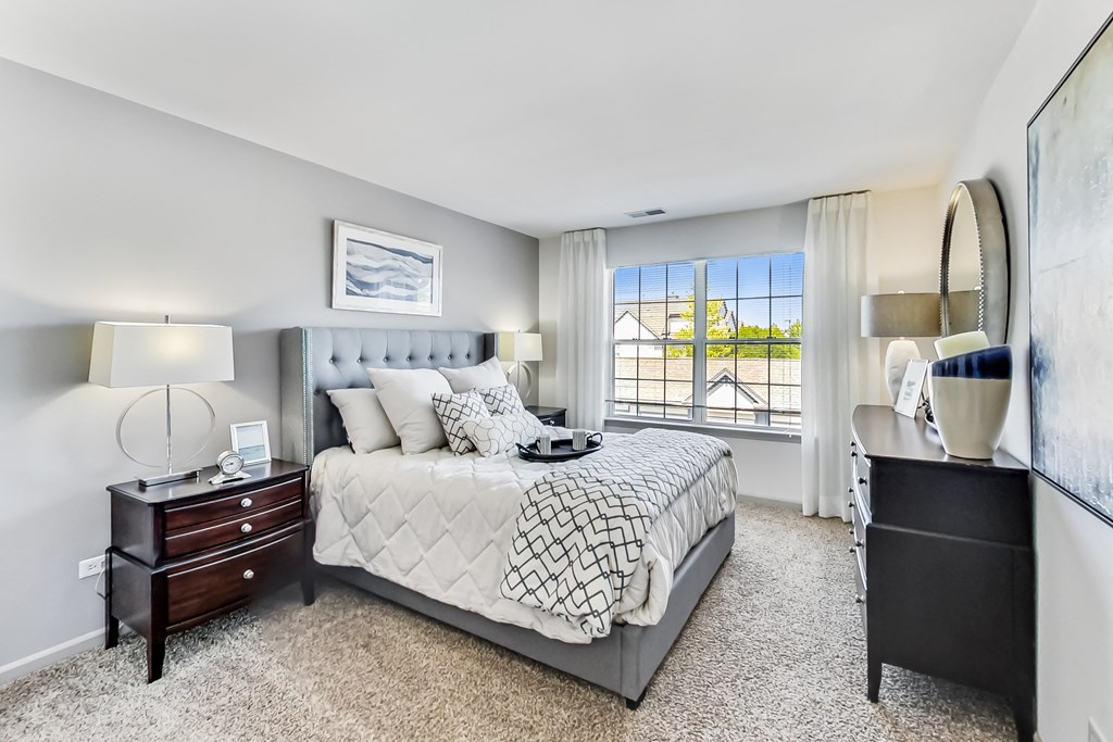 a bedroom with a large bed and a window