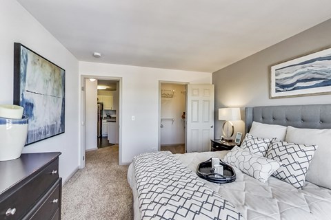 a bedroom with a large bed and a view of the closet and bathroom