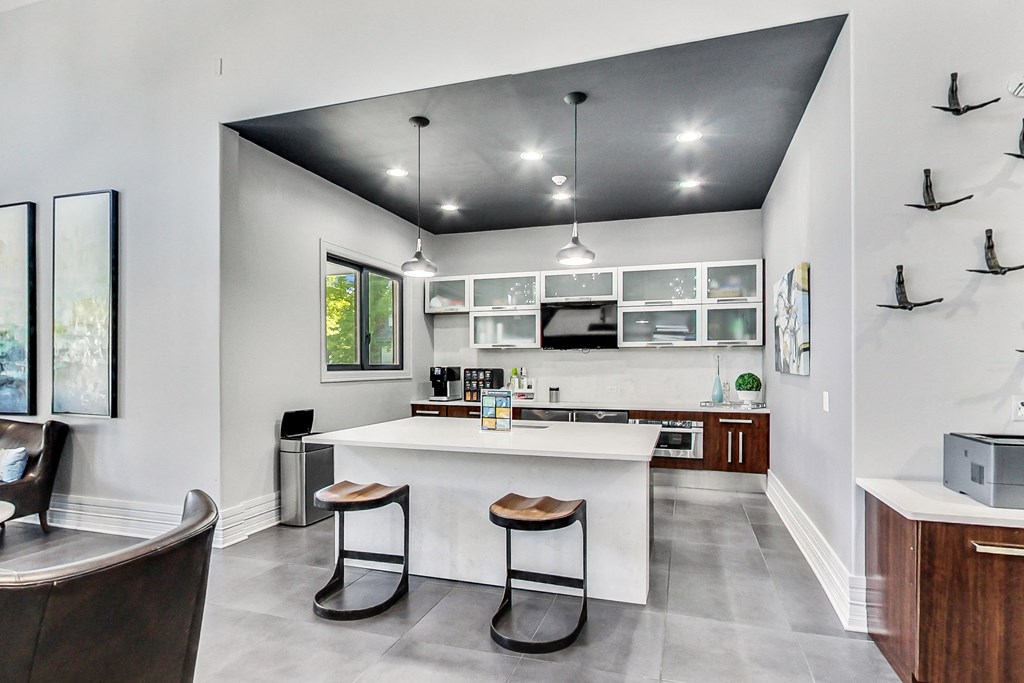 a kitchen with a large island with two stools