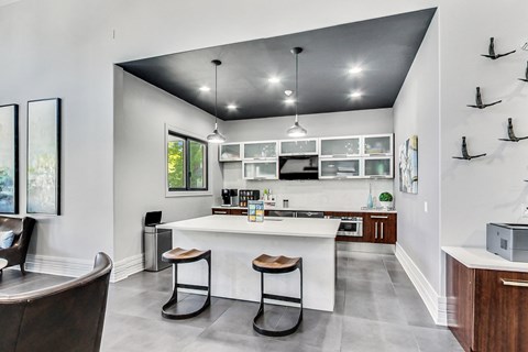 a kitchen with a large island with two stools