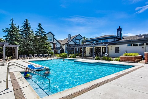 a swimming pool with a building in the background