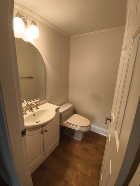 A white bathroom with a toilet and sink.