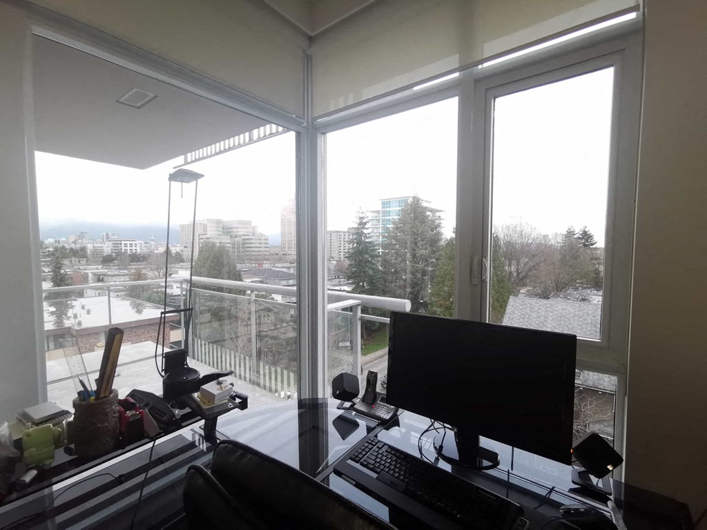a home office with a view of the city from a large window