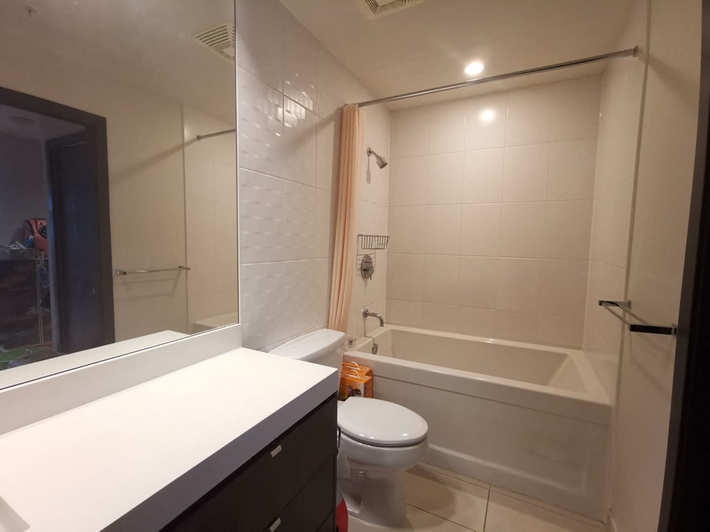 a bathroom with a toilet and a tub and a sink