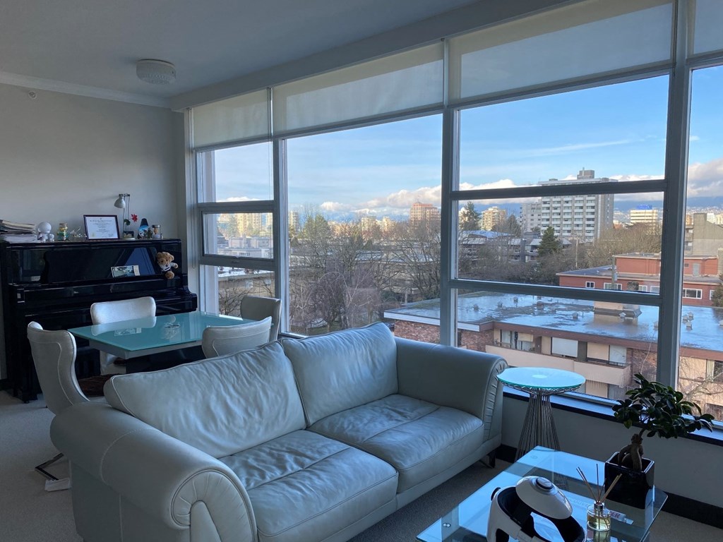 a living room with a white couch and a large window