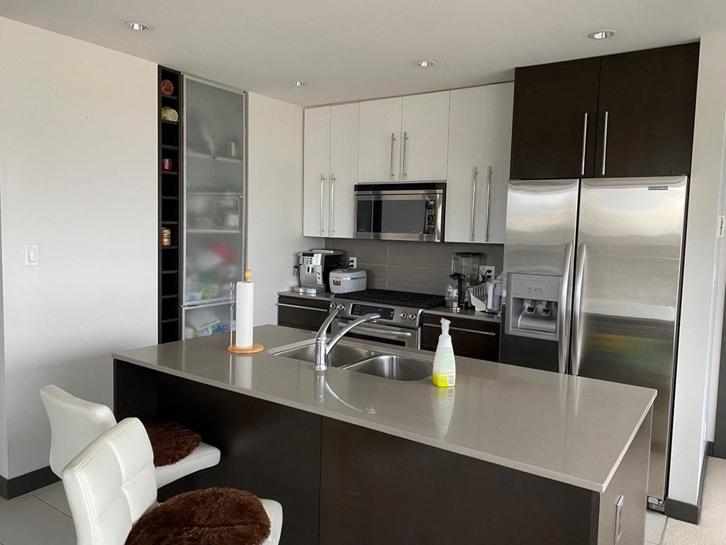 a modern kitchen with stainless steel appliances and a counter top