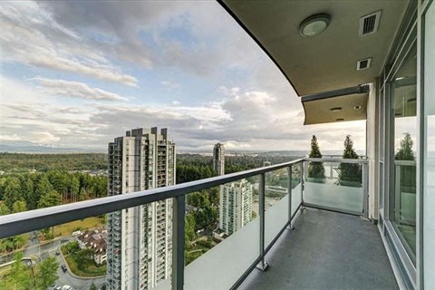 a balcony with a view of a city and some tall buildings