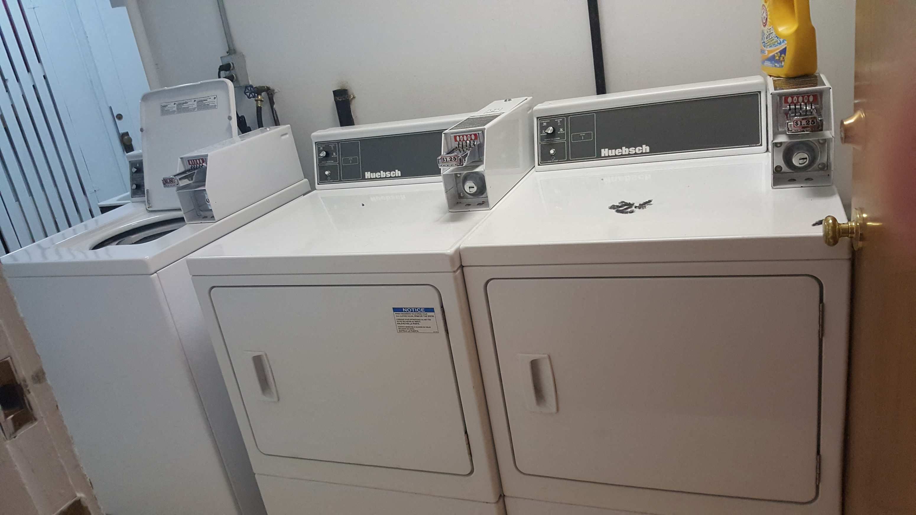 two washers and two dryers in a laundry room